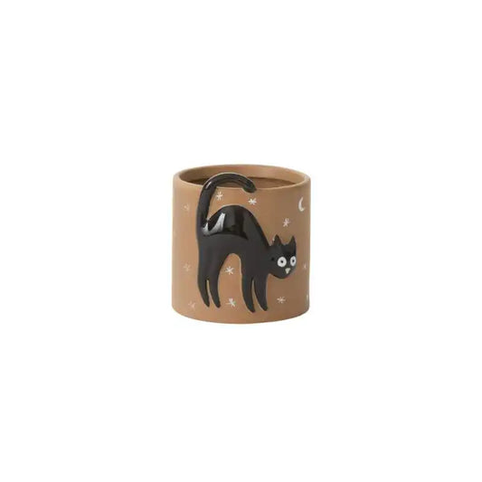 Cylindrical brown pot with a black cat on a white background