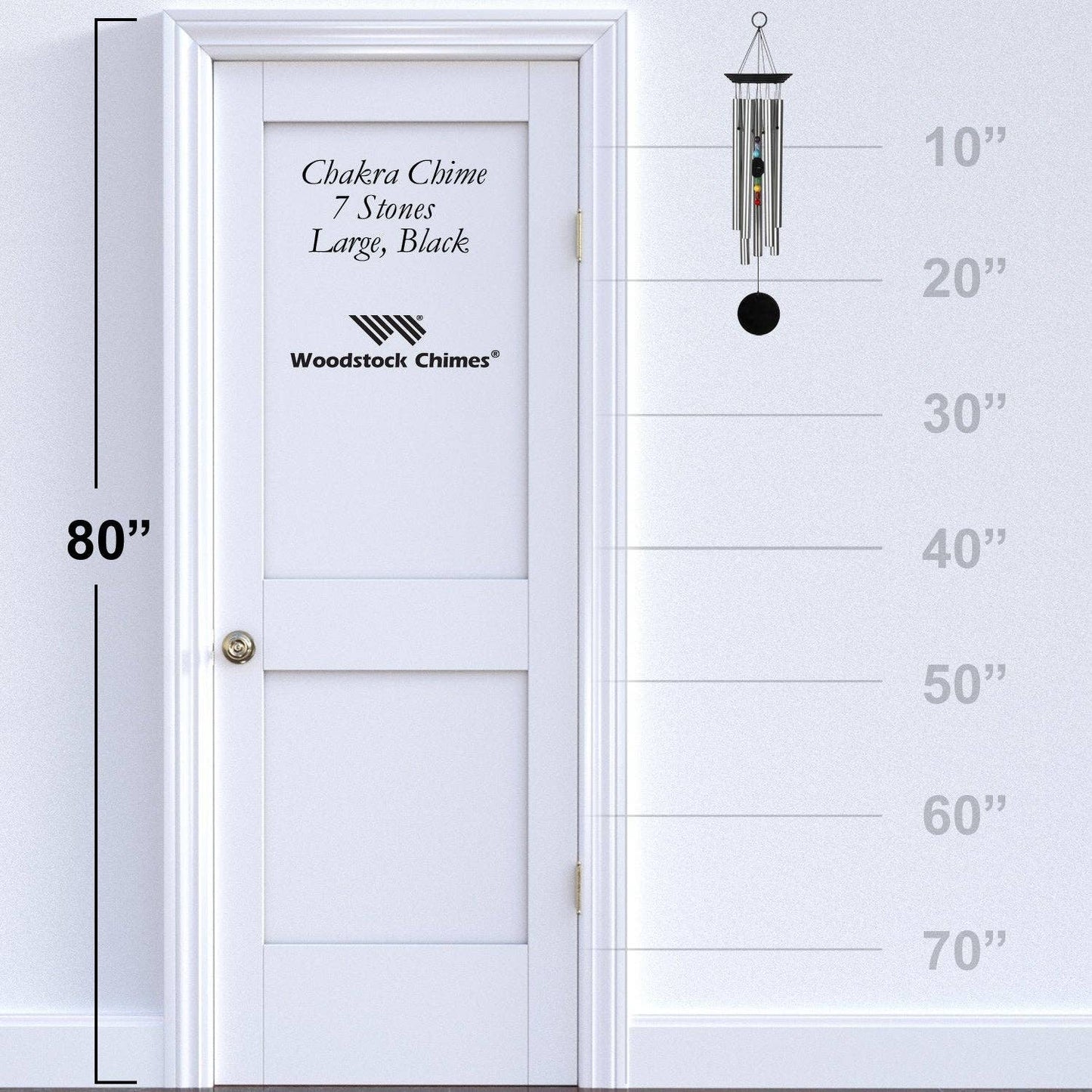Woodstock Chimes wind chime next to a white door with height measurement scale.