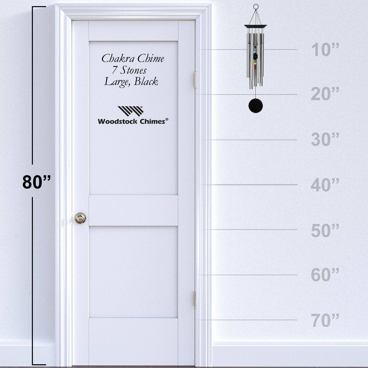 Woodstock Chimes wind chime next to a white door with height measurement scale.