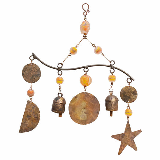 Decorative hanging ornament with rusted metal elements and beads on a white background